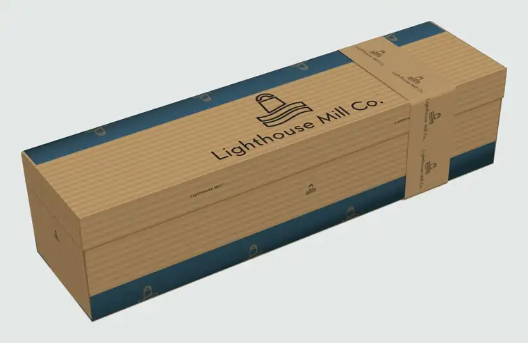 The single Lighthouse Mill box, closed, in natural kraft with a sea blue printed band and the Lighthouse Mill Co. logo on the lid